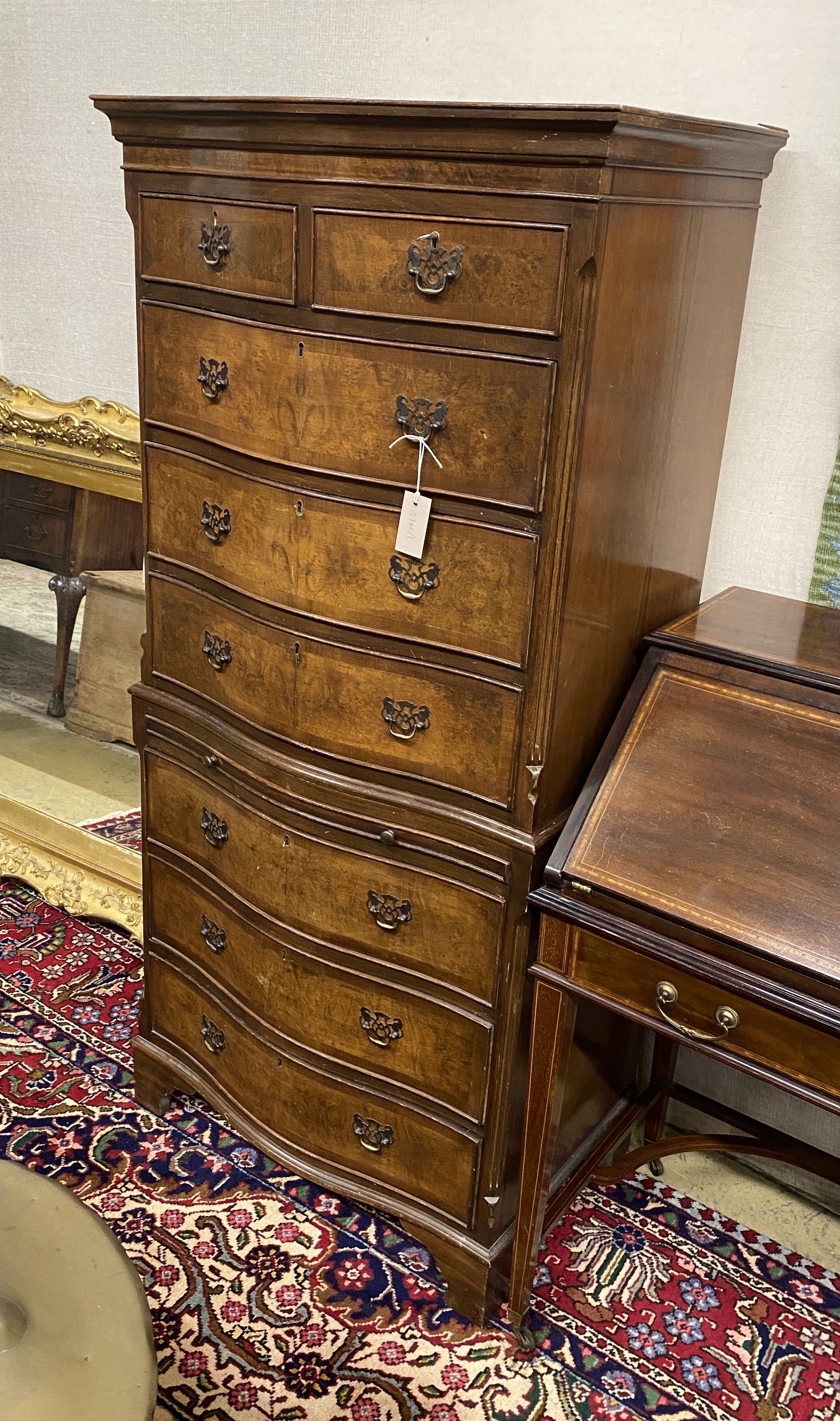 A reproduction George I style walnut serpentine chest on chest, width 70cm, depth 47cm, height 152cm